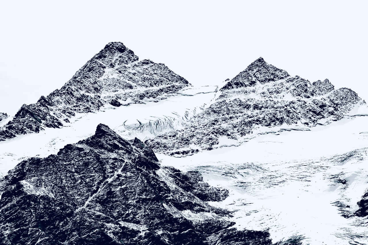 Breathtaking view of snowy mountain peaks, showcasing winter's majesty and serene beauty.