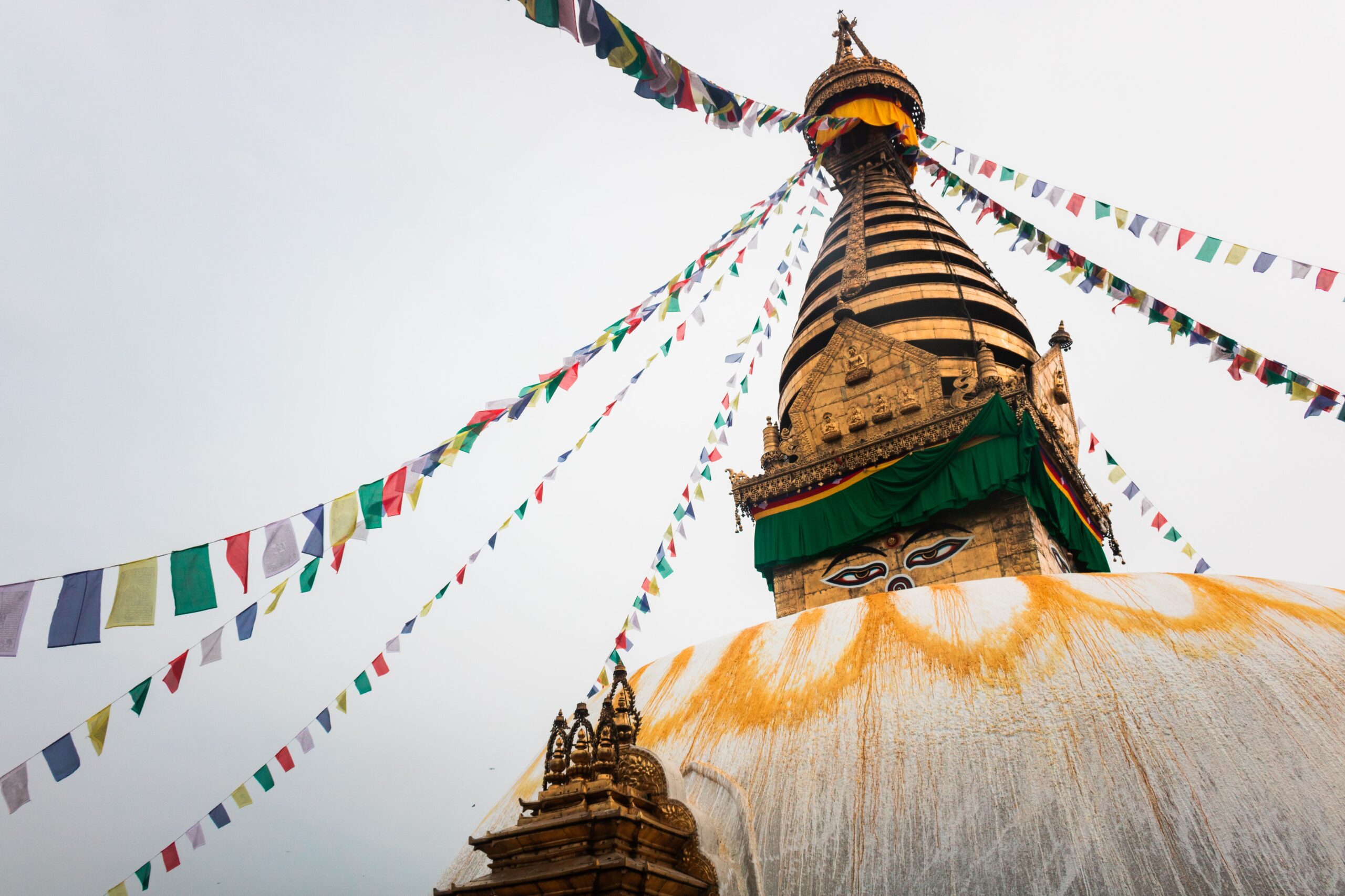 Swayambhunath Stupa in Kathmandu adorned with vibrant prayer flags, a symbol of peace and spirituality.